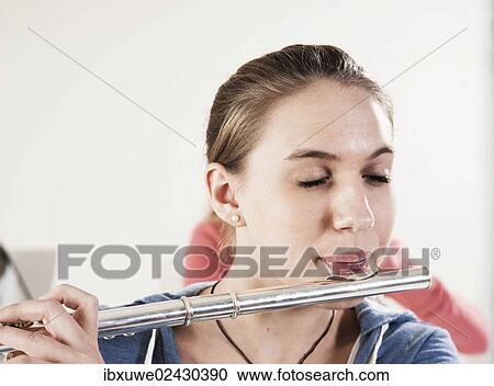 Teenage girl playing the flute View Large Photo Image Stock Image - Teenage girl playing the flute. Fotosearch