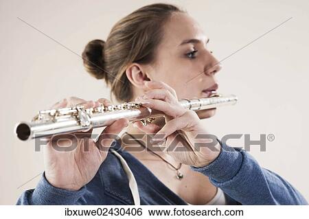 Stock Photograph - Teenage girl playing the flute. Fotosearch