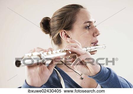 Stock Photography - Teenage girl playing the flute. Fotosearch