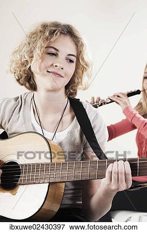 Teenage girl playing the guitar View Large Photo Image Stock Photo - Teenage girl playing the guitar. Fotosearch