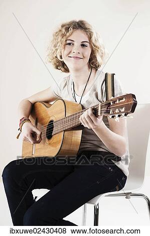 Teenage girl playing the guitar View Large Photo Image Stock Photo - Teenage girl playing the guitar. Fotosearch
