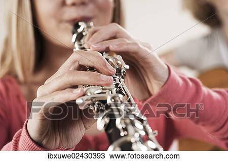 Teenage girl playing the oboe View Large Photo Image Stock Image - Teenage girl playing the oboe. Fotosearch