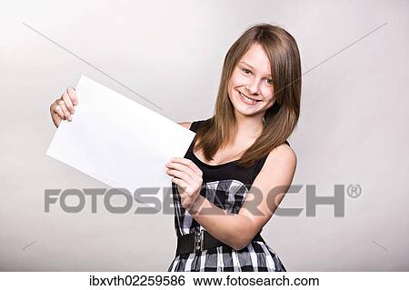 Teenage girl showing blank paper View Large Photo Image Stock Photograph - Teenage girl showing blank paper. Fotosearch