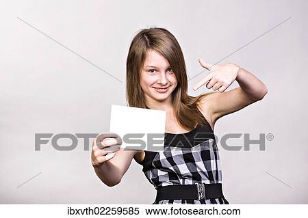 Teenage girl showing blank paper View Large Photo Image Stock Photography - Teenage girl showing blank paper. Fotosearch