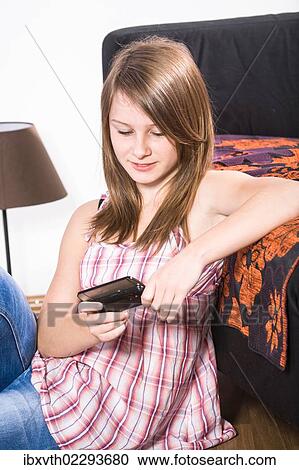 Teenage girl with a mobile phone View Large Photo Image Stock Image - Teenage girl with a mobile phone. Fotosearch