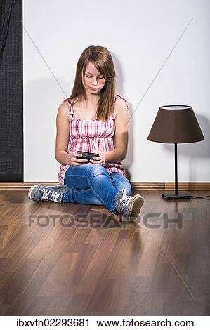 Teenage girl with a mobile phone View Large Photo Image Stock Image - Teenage girl with a mobile phone. Fotosearch
