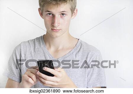 Teenager holding a smartphone View Large Photo Image Stock Image - Teenager holding a smartphone. Fotosearch