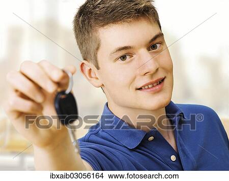Teenager holding car keys after passing a driving test View Large Photo Image Picture - Teenager holding car keys after passing a driving test. Fotosearch
