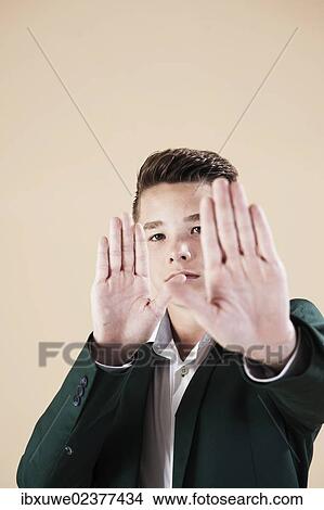 "Teenager in a formal jacket, defensive gesture" View Large Photo Image Picture - "Teenager in a formal jacket, defensive gesture". Fotosearch