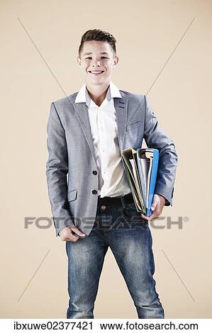 "Teenager in a formal jacket, holding folders" View Large Photo Image Stock Image - "Teenager in a formal jacket, holding folders". Fotosearch