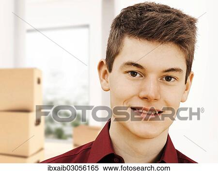 Teenager in front of packing boxes View Large Photo Image Stock Photography - Teenager in front of packing boxes. Fotosearch