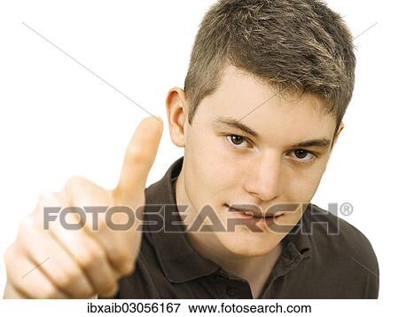 Teenager making a thumbs up gesture View Large Photo Image Stock Photo - Teenager making a thumbs up gesture. Fotosearch