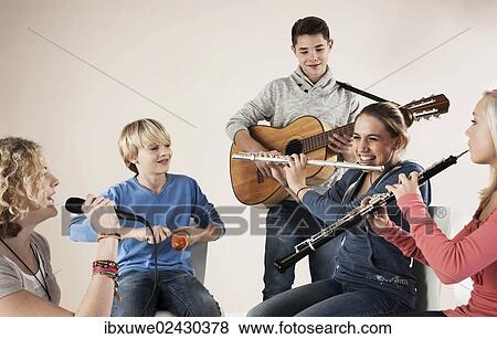Stock Photo - Teenagers making music together. Fotosearch