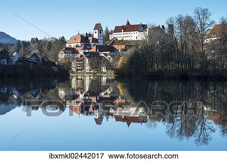 "The former Franciscan Monastery of St. Mang, reflection of the castle at top in the Lech river, Fuessen, Ostallgaeu region, Allgaeu, Bavaria, Germany, Europe" View Large Photo Image Stock Photo - "The former Franciscan Monastery of St. Mang, reflection of the castle at top in the Lech river, Fuessen, Ostallgaeu region, Allgaeu, Bavaria, Germany, Europe". Fotosearch