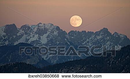 "The full moon rising over the Kaiser Mountains, Tyrol, Austria, Europe" View Large Photo Image Stock Photo - "The full moon rising over the Kaiser Mountains, Tyrol, Austria, Europe". Fotosearch