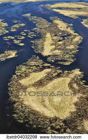 Stock Photo - "The Gomoti River with its channels and islands, aerial view, Okavango Delta, Botswana, Africa". Fotosearch
