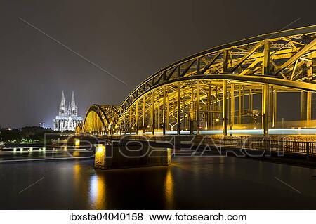 "The illuminated Cologne Cathedral and Hohenzollern Bridge at night with Rhine, Deutz, Cologne, North Rhine-Westphalia, Germany, Europe" View Large Photo Image Stock Photo - "The illuminated Cologne Cathedral and Hohenzollern Bridge at night with Rhine, Deutz, Cologne, North Rhine-Westphalia, Germany, Europe". Fotosearch