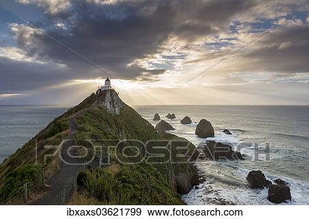 Stock Photo - "The Lighthouse at Nugget Point at sunrise, Nugget Point, Ahuriri Flat, Otago Region, New Zealand, Oceania". Fotosearch