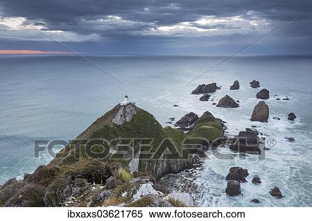 Stock Photography - "The Lighthouse at Nugget Point before sunrise, Nugget Point, Ahuriri Flat, Otago Region, New Zealand, Oceania". Fotosearch