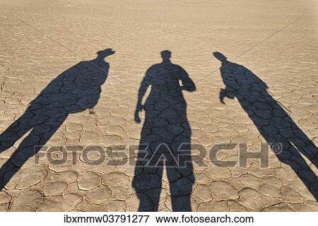 "The shadows of people on dry salt pan, Dead Pan, Sossusvlei, Namib Desert, Namibia, Africa" View Large Photo Image Stock Photo - "The shadows of people on dry salt pan, Dead Pan, Sossusvlei, Namib Desert, Namibia, Africa". Fotosearch