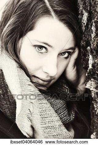 Stock Photograph - "Thoughtful young woman wearing a scarf, portrait". Fotosearch