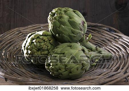 Three artichokes (Cynara cardunculus) in a basket View Large Photo Image Stock Photo - Three artichokes (Cynara cardunculus) in a basket. Fotosearch