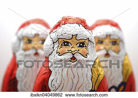 Stock Image - Three chocolate Santas. Fotosearch