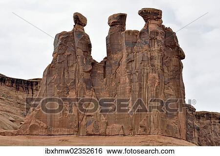 Stock Photograph - "Three Gossips, rock formation of red sandstone, Arches National Park, Moab, Utah, USA". Fotosearch