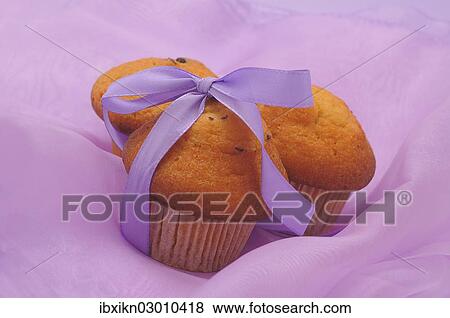 Three muffins with a ribbon View Large Photo Image Stock Photo - Three muffins with a ribbon. Fotosearch