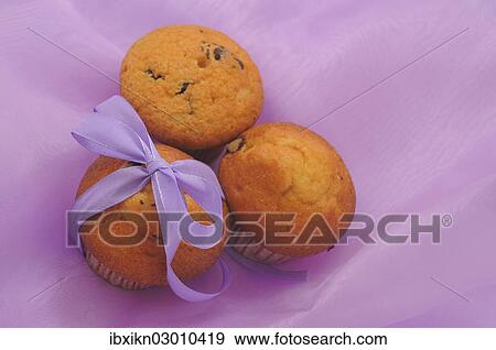 Three muffins with a ribbon View Large Photo Image Stock Photo - Three muffins with a ribbon. Fotosearch