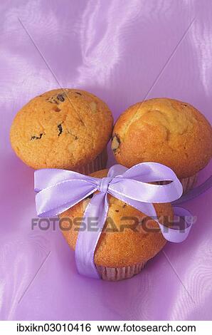 Stock Photograph - Three muffins with a ribbon. Fotosearch