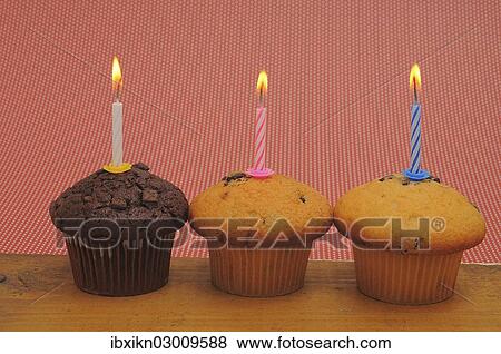 Three muffins with birthday candles View Large Photo Image Stock Photo - Three muffins with birthday candles. Fotosearch