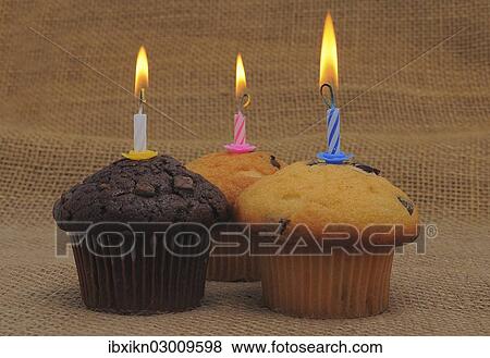 Three muffins with birthday candles View Large Photo Image Stock Photo - Three muffins with birthday candles. Fotosearch