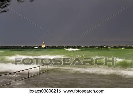 Stock Photography - "Thunderstorm and high waves at the Horn outdoor pool, rainbow over Lake Constance, Konstanz, Baden-Wurttemberg, Germany, Europe". Fotosearch
