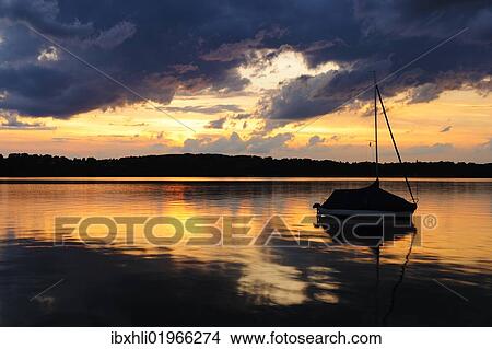 Picture - "Thunderstorm at sunset on near the Seeburg on Lake Starnberg, Allmannshausen, Bavaria, Germany, Europe". Fotosearch