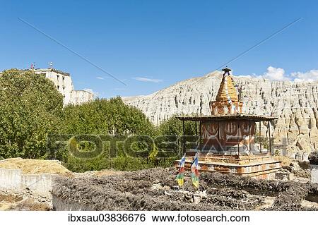 "Tibetan Buddhism, colorful ornate stupa, white ruins, the old Royal Palace at the back left, Dzong architecture, eroded landscape, Charang, Mustang District, Nepal, Asia" View Large Photo Image Stock Photograph - "Tibetan Buddhism, colorful ornate stupa, white ruins, the old Royal Palace at the back left, Dzong architecture, eroded landscape, Charang, Mustang District, Nepal, Asia". Fotosearch
