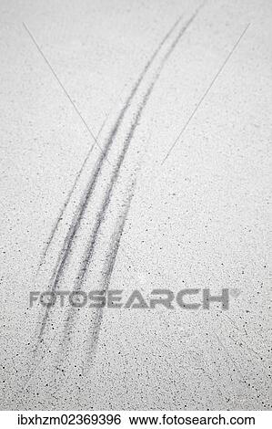 Stock Photograph - "Tire tracks, skid marks on a parking lot". Fotosearch