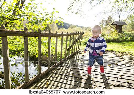 "Toddler, 18 months, playing in the garden" View Large Photo Image Stock Photo - "Toddler, 18 months, playing in the garden". Fotosearch