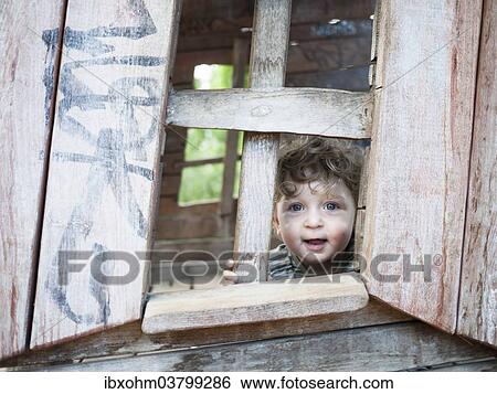 "Toddler looking out of a playhouse, Germany, Europe" View Large Photo Image Stock Photograph - "Toddler looking out of a playhouse, Germany, Europe". Fotosearch