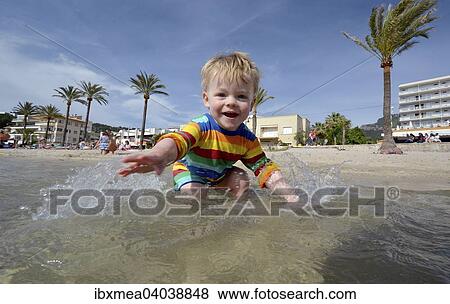 "Toddler playing at the beach, Port de Soller, Majorca, Balearic Islands, Spain, Europe" View Large Photo Image Stock Photo - "Toddler playing at the beach, Port de Soller, Majorca, Balearic Islands, Spain, Europe". Fotosearch
