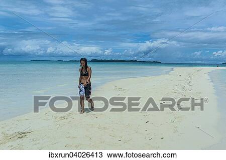 "Tourist walking on a sand strip at low tide, Rock Islands, Palau, Oceania" View Large Photo Image Stock Image - "Tourist walking on a sand strip at low tide, Rock Islands, Palau, Oceania". Fotosearch