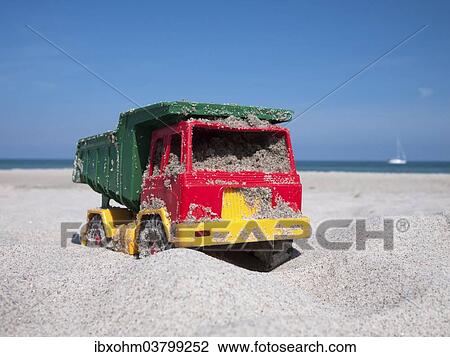 "Toy dumper truck on a beach, Mecklenburg-Western Pomerania, Germany, Europe" View Large Photo Image Stock Image - "Toy dumper truck on a beach, Mecklenburg-Western Pomerania, Germany, Europe". Fotosearch
