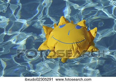 Toy sun floating in a swimming pool View Large Photo Image Stock Image - Toy sun floating in a swimming pool. Fotosearch