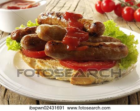 Traditional chipolata pork sausages in tomato ketchup sandwich View Large Photo Image Stock Image - Traditional chipolata pork sausages in tomato ketchup sandwich. Fotosearch