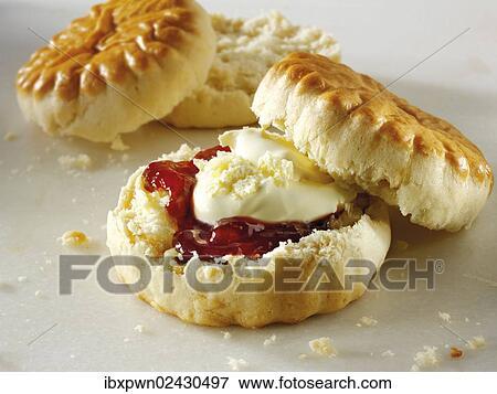"Traditional English scones with clotted cream, thickened cream and jam" View Large Photo Image Stock Photo - "Traditional English scones with clotted cream, thickened cream and jam". Fotosearch