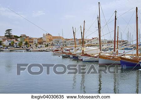 "Traditional sailing boats with lateen sail, Vela Latina, in the port of Calasetta, Isola di Sant'Antioco, Province of Carbonia-Iglesias, Sardinia, Italy, Europe" View Large Photo Image Stock Photography - "Traditional sailing boats with lateen sail, Vela Latina, in the port of Calasetta, Isola di Sant'Antioco, Province of Carbonia-Iglesias, Sardinia, Italy, Europe". Fotosearch