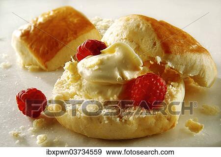 Traditional scone with clotted cream and raspberries View Large Photo Image Stock Photo - Traditional scone with clotted cream and raspberries. Fotosearch