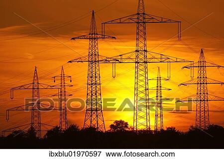Stock Photo - "Transmission lines, overhead line towers, with setting sun, Beinstein in Stuttgart, Baden-Wuerttemberg, Germany, Europe". Fotosearch