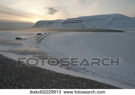"Trapper huts at Cape Schoulz at sunset on the partially frozen Tempelfjorden, Spitsbergen, Svalbard, Norway, Europe" View Large Photo Image Stock Image - "Trapper huts at Cape Schoulz at sunset on the partially frozen Tempelfjorden, Spitsbergen, Svalbard, Norway, Europe". Fotosearch