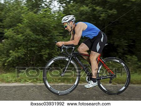 "Triathlete, 45 years, cycling, Kaiserstrassle road, Baden-Wurttemberg, Germany, Europe" View Large Photo Image Stock Image - "Triathlete, 45 years, cycling, Kaiserstrassle road, Baden-Wurttemberg, Germany, Europe". Fotosearch